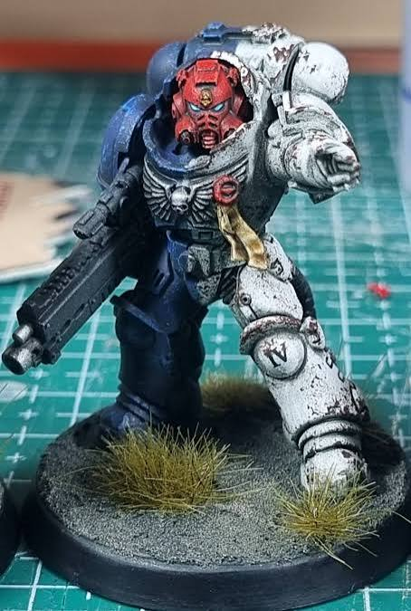 Painted Space Marine with red helmet and dark blue armour